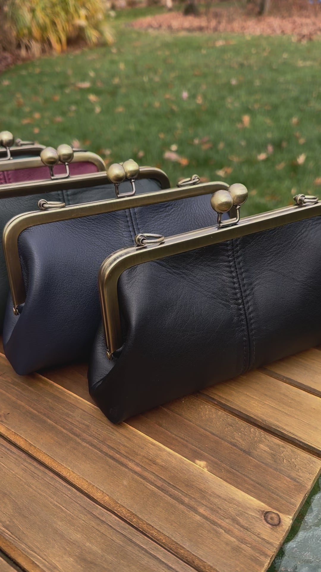Collection of handcrafted leather kiss lock purses with bronze hardware and chain straps. Wear as clutch, shoulder, or crossbody. Made in Maryland.