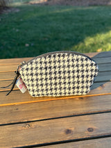 The Seashell Pouch in Black & White Houndstooth Harris Tweed® has a curved top and flat base that stands up on its own, lined with natural heavy canvas.