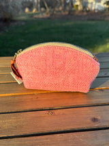 The Seashell Pouch in Pink Twill Harris Tweed® has a curved top and flat base that stands up on its own, lined with natural heavy canvas.