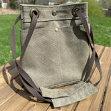 Olive Drab Stone Washed Canvas with and Antique Brass Hardware and Dark Brown Webbing Strap and Natural Canvas interior Spa Creek Bucket Convertible Bag squirescanvascreations.com