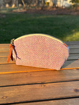 The Seashell Pouch in Pink & Blue Wide Herringbone Harris Tweed® has a curved top and flat base that stands up on its own, lined with natural heavy canvas.