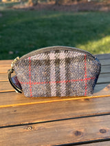 The Seashell Pouch in Navy Black and Red Overchecks Harris Tweed® has a curved top and flat base that stands up on its own, lined with natural heavy canvas.