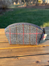 The Seashell Pouch in Navy Windowpane Harris Tweed® has a curved top and flat base that stands up on its own, lined with natural heavy canvas.