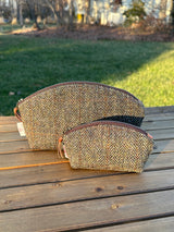 The Seashell Pouch in Green and Brown Herringbone Harris Tweed® has a curved top and flat base that stands up on its own, lined with natural heavy canvas. Large and Small