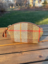 The Seashell Pouch in MacLeod Harris Tweed® has a curved top and flat base that stands up on its own, lined with natural heavy canvas.