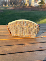 The Seashell Pouch in Blue Green Herringbone Harris Tweed® has a curved top and flat base that stands up on its own, lined with natural heavy canvas.