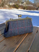 Harris Tweed® kiss lock purse in Dark Navy Plaid with bronze hardware. Wear as a clutch, attach chain for shoulder or crossbody wear. Holds phone, cards, and small items. Timeless design handcrafted in Maryland. 