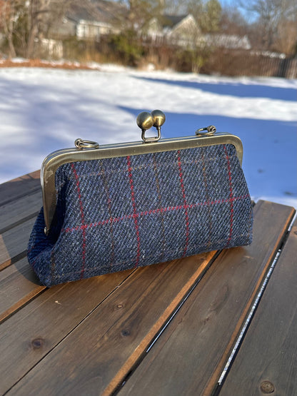 Harris Tweed® kiss lock purse in Dark Navy Plaid with bronze hardware. Wear as a clutch, attach chain for shoulder or crossbody wear. Holds phone, cards, and small items. Timeless design handcrafted in Maryland. 