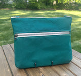 Front View Handcrafted Canvas Bayside Slim Crossbody Bag in Forest Green canvas with cotton canvas lining and adjustable Splenda vegetable-tanned leather strap. Lightweight and perfect for everyday wear.