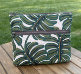 Front View Handcrafted Rifle Paper Co. Canvas Bayside Slim Crossbody Bag in Monstera Canvas with cotton canvas lining and adjustable Splenda vegetable-tanned leather strap.