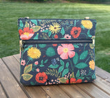 Front View Handcrafted Rifle Paper Co. Canvas Bayside Slim Crossbody Bag in Navy Botanical Floral Canvas with cotton canvas lining and adjustable Splenda vegetable-tanned leather strap.