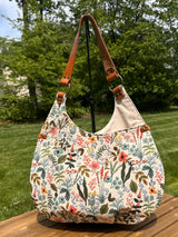 Compass Rose Shoulder bag showing the Rifle Paper Co. Herb Garden Natural Canvas with Cognac Leather.