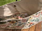 Close up interior view of the Compass Rose Shoulder bag in Rifle Paper Co. Herb Garden Natural Canvas.  Shows interior slip pocket and magnetic snap closure.