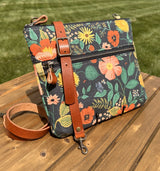 Front View Handcrafted Rifle Paper Co. Canvas Bayside Slim Crossbody Bag in Navy Botanical Floral Canvas with cotton canvas lining and adjustable Splenda vegetable-tanned leather strap.