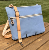 Front View Handcrafted Canvas Bayside Slim Crossbody Bag in Light Blue canvas with cotton canvas lining and adjustable Splenda vegetable-tanned leather strap. Lightweight and perfect for everyday wear.