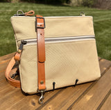 Front View Handcrafted Canvas Bayside Slim Crossbody Bag in linen color canvas with cotton canvas lining and adjustable Splenda vegetable-tanned leather strap. Lightweight and perfect for everyday wear.