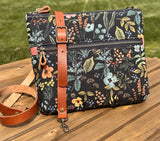 Front View Handcrafted Rifle Paper Co. Canvas Bayside Slim Crossbody Bag in Midnight Herb Garden Canvas with cotton canvas lining and adjustable Splenda vegetable-tanned leather strap.