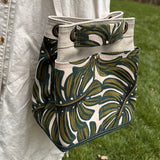 Monstera Canvas with Forest Green Duck Canvas and Antique Brass Hardware and Natural Webbing Strap and Natural Canvas interior Spa Creek Bucket Convertible Bag squirescanvascreations.com