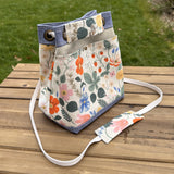 Strawberry Fields Canvas with Harbor Blue Stone Washed Canvas and Antique Brass Hardware and Natural Webbing Strap and Natural Canvas interior Spa Creek Bucket Convertible Bag squirescanvascreations.com