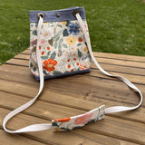 Strawberry Fields Canvas with Harbor Blue Stone Washed Canvas and Antique Brass Hardware and Natural Webbing Strap and Natural Canvas interior Spa Creek Bucket Convertible Bag squirescanvascreations.com