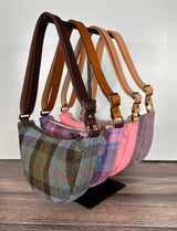 Collection of Handcrafted Harris Tweed Half Moon Shaped bag with full-grain vegetable-tanned leather strap with brass hardware, unisex, made in Maryland.