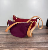 Group of Canvas Windward Sling,  Burgundy Canvas with Natural Splenda Leather Strap and Antique Brass Hardware and a Large Scarlet Canvas with Natural Splenda Leather Strap and Antique Brass Hardware.