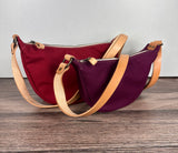 Group of Canvas Windward Sling,  Burgundy Canvas with Natural Splenda Leather Strap and Antique Brass Hardware and a Large Scarlet Canvas with Natural Splenda Leather Strap and Antique Brass Hardware.