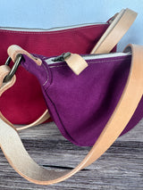 Group of Canvas Windward Sling,  Burgundy Canvas with Natural Splenda Leather Strap and Antique Brass Hardware and a Large Scarlet Canvas with Natural Splenda Leather Strap and Antique Brass Hardware.