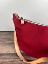 Close up view of a Burgundy Canvas with Natural Splenda Leather Strap and Antique Brass Hardware Canvas Windward Sling.