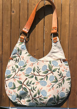 View of the Compass Rose Shoulder Bag in Rifle Paper Co. Wildwood Peonies Cream Canvas with Cognac Leather.