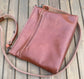 Overhead view of a handcrafted Leather Bayside Crossbody bag in Sienna Horween leather, showcasing its rich, warm color, natural grain, solid brass hardware, and full metal zipper. Designed and made in Maryland.