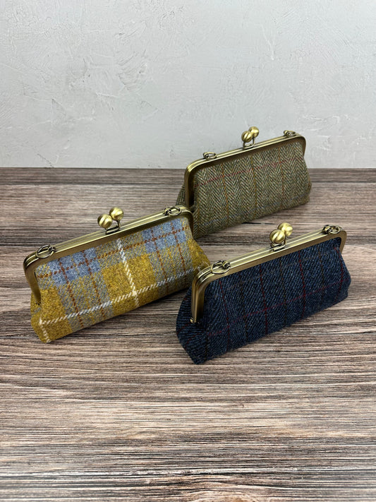 Collection of handcrafted Harris Tweed® kiss lock purses with bronze hardware. Classic clutch style with 2 card slots, fits a phone and small essentials. Wear as a clutch, shoulder bag, or crossbody. Made in Maryland, perfect for special occasions.