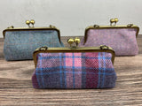Collection of handcrafted Harris Tweed® kiss lock purses with bronze hardware. Classic clutch style with 2 card slots, fits a phone and small essentials. Wear as a clutch, shoulder bag, or crossbody. Made in Maryland, perfect for special occasions.