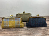 Collection of handcrafted Harris Tweed® kiss lock purses with bronze hardware. Classic clutch style with 2 card slots, fits a phone and small essentials. Wear as a clutch, shoulder bag, or crossbody. Made in Maryland, perfect for special occasions.