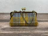 Harris Tweed® kiss lock purse in Yellow and Blue Plaid with bronze hardware. Wear as a clutch, attach chain for shoulder or crossbody wear. Holds phone, cards, and small items. Timeless design handcrafted in Maryland. 