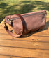 Front view of Leather Spinnaker Sling bag in Vintage Dark Brown Leather with bronze hardware, linen interior, and front zipper. Unisex slim crossbody sling handmade in Maryland.