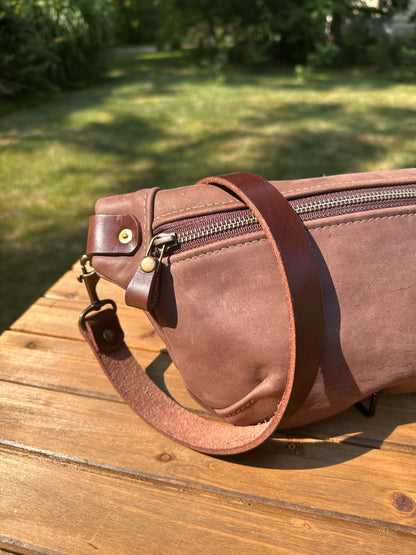 Close-up detail of the front zipper and grain texture on the Leather Spinnaker Sling in Vintage Dark Brown Leather, with solid brass hardware and full-grain leather.