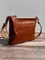 Front view of a handcrafted Leather Bayside Crossbody bag in Sienna Horween leather, showcasing its rich, warm color, natural grain, solid brass hardware, and full metal zipper. Designed and made in Maryland.