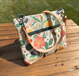 Back View Handcrafted Rifle Paper Co. Canvas Bayside Slim Crossbody Bag in Natural Botanical Floral Canvas with cotton canvas lining and adjustable Splenda vegetable-tanned leather strap.