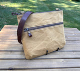 Front View Handcrafted Canvas Bayside Slim Crossbody Bag in Sandstone Hybrid waxed canvas with cotton canvas lining and adjustable Splenda vegetable-tanned leather strap. Lightweight and perfect for everyday wear.
