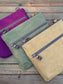 Collection of handcrafted Canvas Bayside Slim Crossbody Bags in  waxed canvas, and solid canvas styles, with full canvas lining and adjustable vegetable-tanned leather straps.