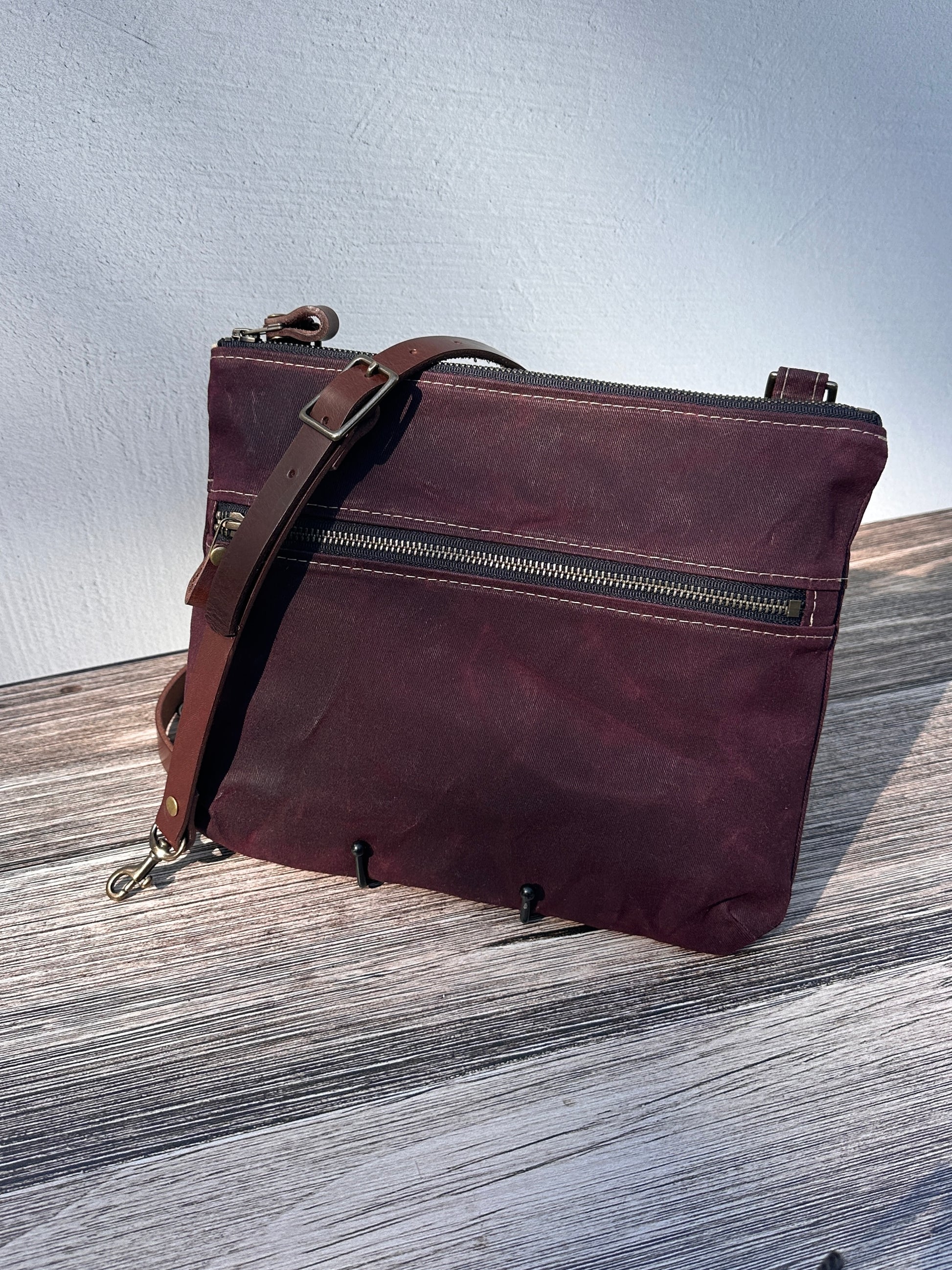 Front View Handcrafted Canvas Bayside Slim Crossbody Bag in Burgundy Waxed Twill with cotton canvas lining and adjustable Splenda vegetable-tanned leather strap. Lightweight and perfect for everyday wear.