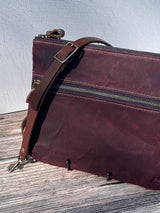 Up Close Front View Handcrafted Canvas Bayside Slim Crossbody Bag in Burgundy Waxed Twill with cotton canvas lining and adjustable Splenda vegetable-tanned leather strap. Lightweight and perfect for everyday wear.