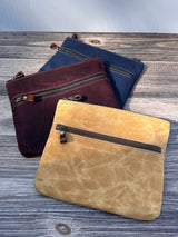 Collection of handcrafted Canvas Bayside Slim Crossbody Bags in waxed canvas, and solid canvas styles, with full canvas lining and adjustable vegetable-tanned leather straps.