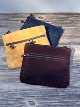 Collection of handcrafted Canvas Bayside Slim Crossbody Bags in waxed canvas, and solid canvas styles, with full canvas lining and adjustable vegetable-tanned leather straps.