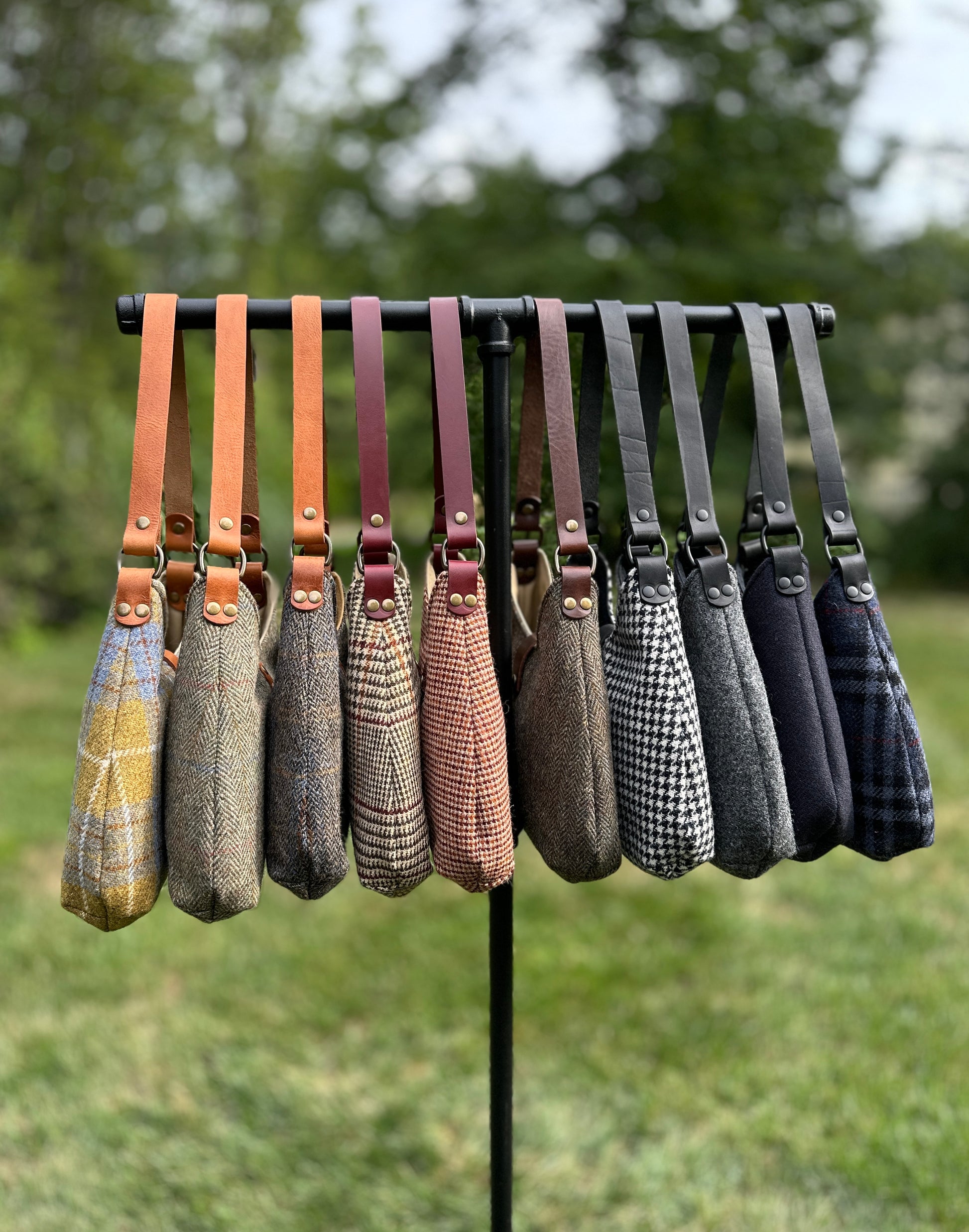 Harris Tweed® Rhode River Shoulder Bags group shot, 10 fabric-and-leather combos. Handcrafted in Maryland