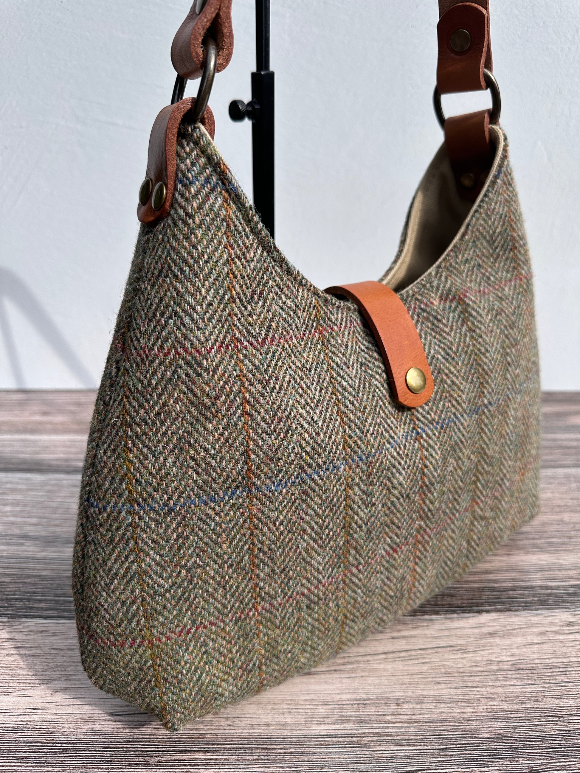 up close view Green Mix Herringbone Harris Tweed® Rhode River Shoulder Bags,  Cognac Leather with Antique Brass Hardware. Handcrafted in Maryland