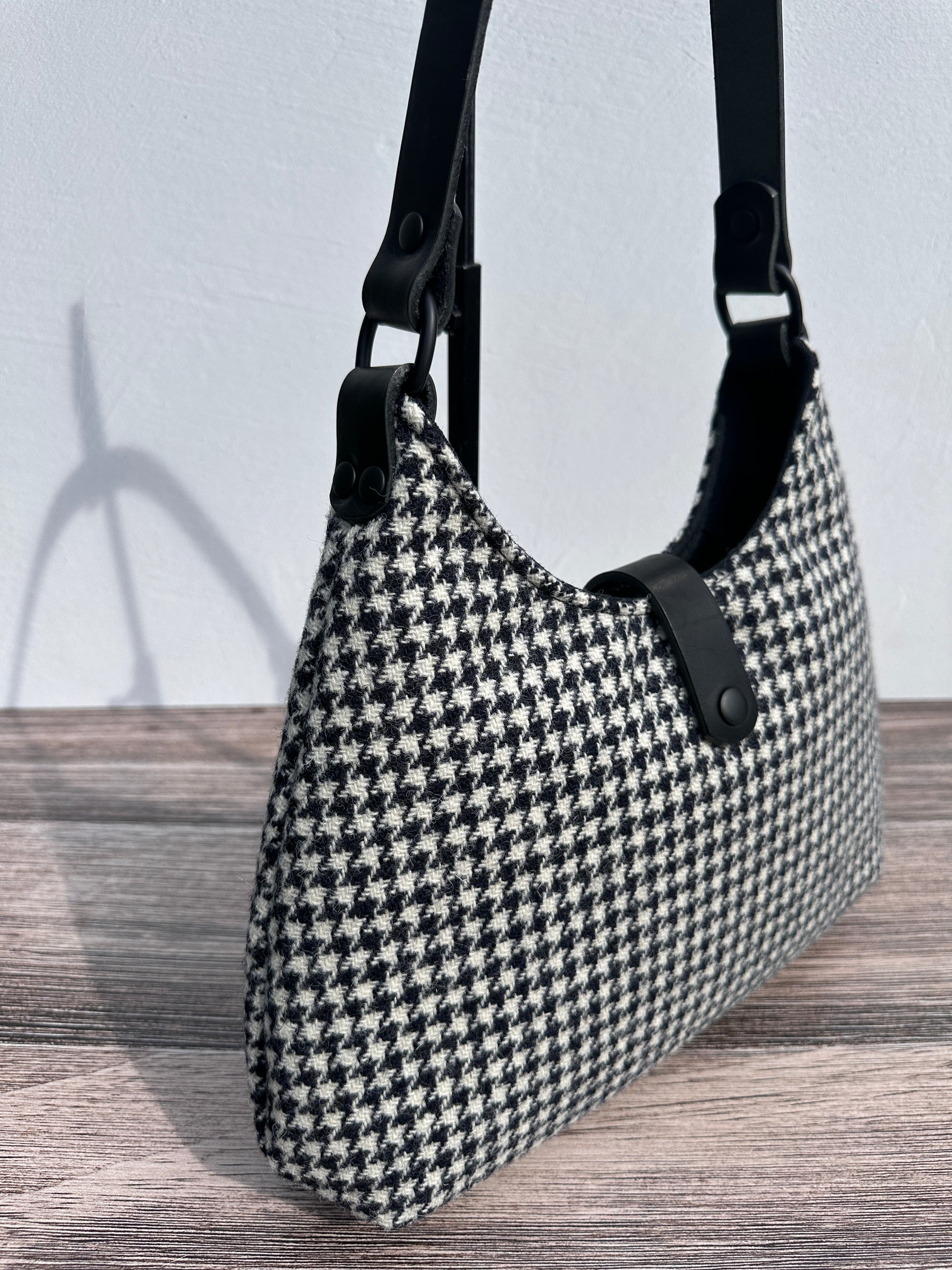 Close up view Black and White Houndstooth Harris Tweed® Rhode River Shoulder Bags,  Black Leather with Black Matte Hardware. Handcrafted in Maryland