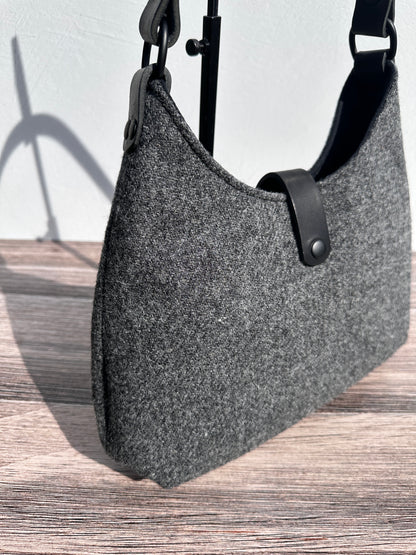 Close up view Mid Grey Twill  Harris Tweed® Rhode River Shoulder Bags,  Black Leather with Black Matte Hardware. Handcrafted in Maryland