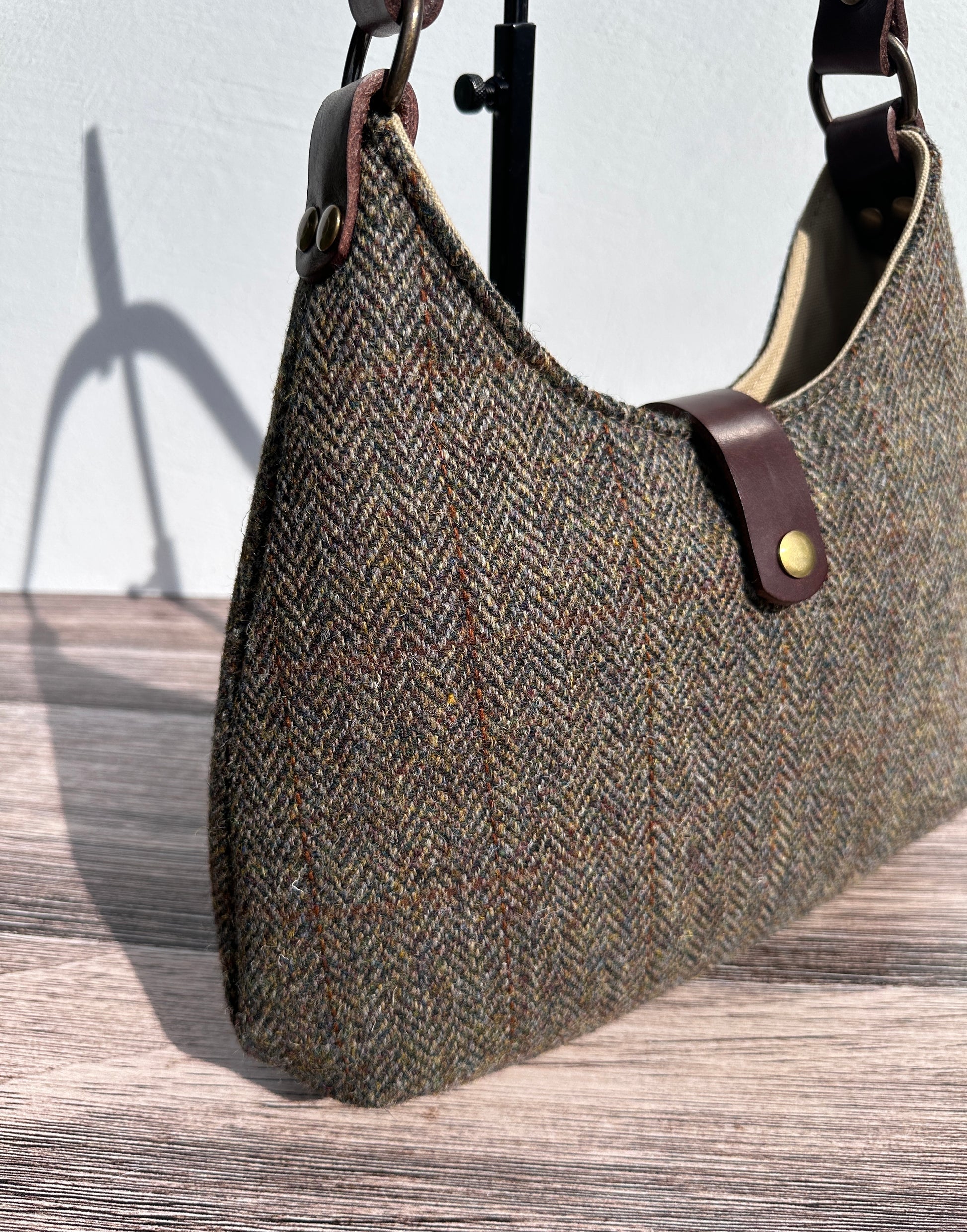 Close Up view Green and Brown Herringbone Harris Tweed® Rhode River Shoulder Bags,  Dark Brown Leather with Antique Brass Hardware. Handcrafted in Maryland